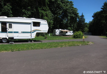 View around middle of loop. RV in site #18 on left with #20 behind it. Shaded section behind that.
