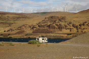 View of a smaller camper by the river
