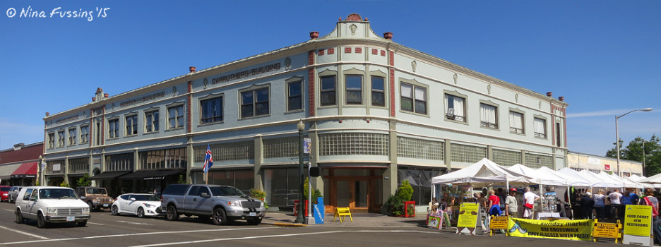 Downtown Astoria architecture. The Sunday farmer's market is rocking the tents on the right.