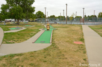 Mini-golf area with tennis and pickeball courts in the background.
