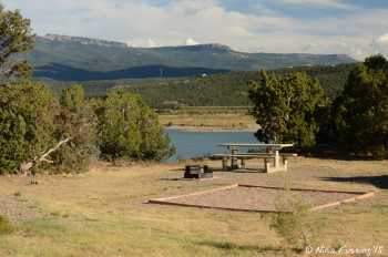 "Sitting area" with picnic table and fire-pit. This is water-view site #52. It also has a tent spot.
