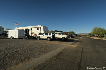 View down back row on north side. RV in site #91 in front with #92-95 behind.