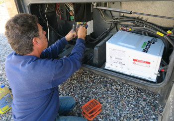 Marv removing our old solar controller & inverter from the external bay