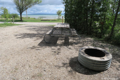 Typical "sitting area" with picnic table and firepit. This is one of the water-view sites in section S, #183