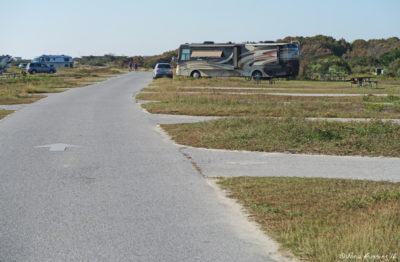 View down I loop towards our RV. Empty site I20 on right. We are in I32 6 sites behing it